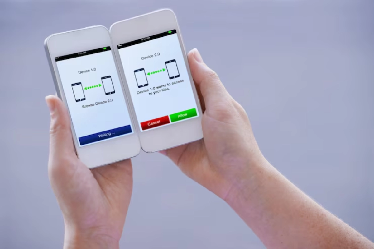 Two hands hold smartphones displaying connection prompts: one waiting for access and the other requesting file permission.