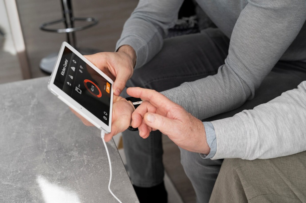 Two hands interact with a tablet displaying a timer, showcasing a cooking or home automation app in a modern living space.