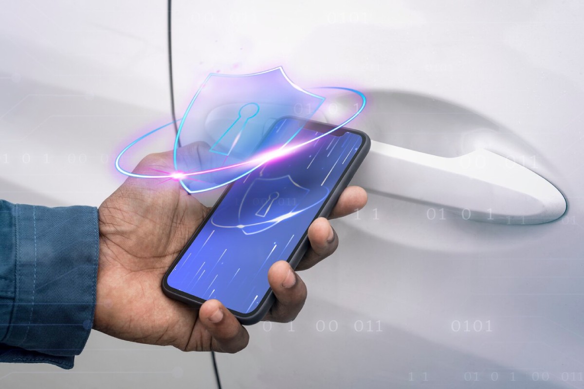 A hand holds a smartphone displaying a digital lock icon, near a car door handle, symbolizing mobile car unlocking technology.