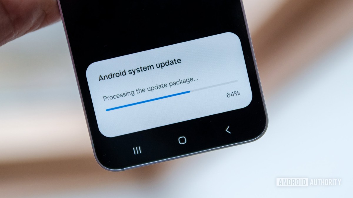 A hand holds a smartphone displaying an Android system update progress screen at 64% completion.