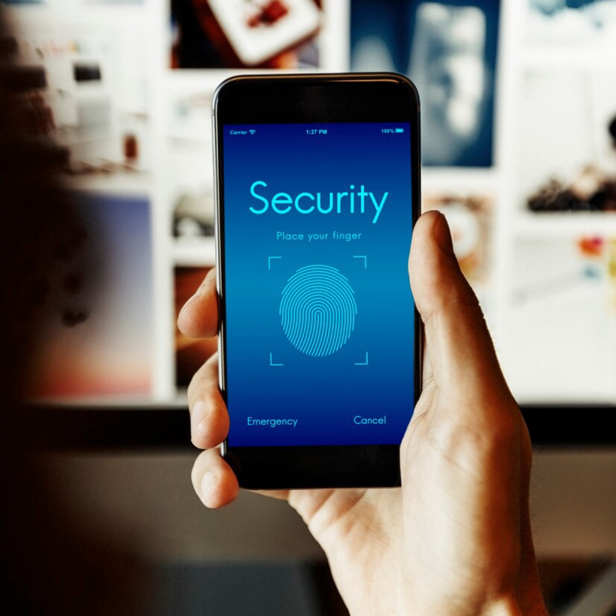 A hand holds a smartphone displaying a fingerprint security interface, prompting the user to place their finger for verification.