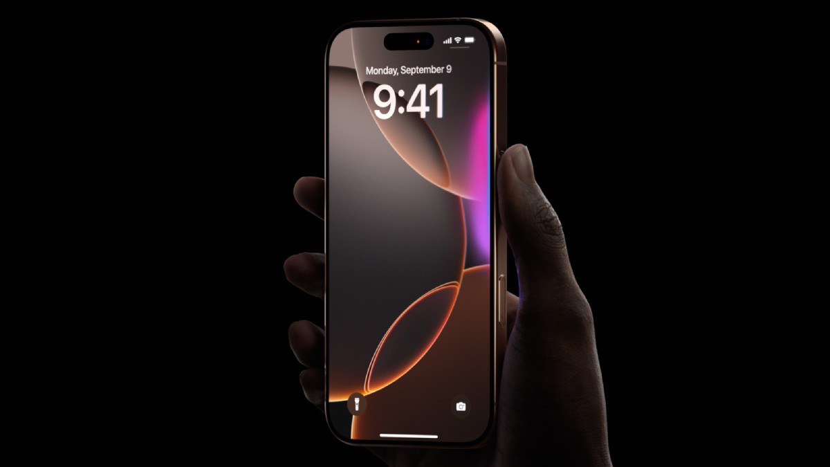 A hand holding an iPhone 14 Pro, displaying a colorful lock screen with the time 9:41 and a date of September 9, against a black background.
